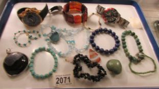 A mixed lot of stone pendants, bracelets etc and two wrist watches.