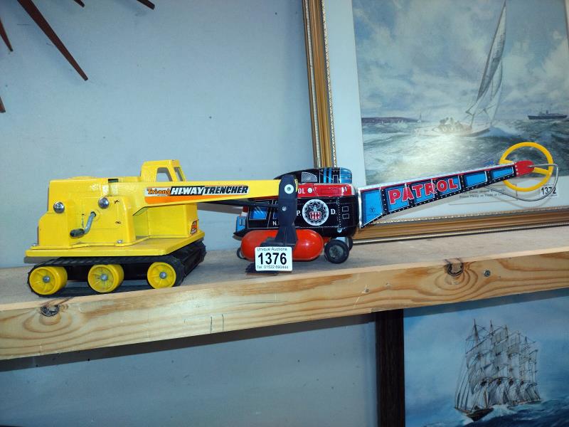 A Japanese tinplate battery operated helicopter A/F and a Triang Hi-Way trencher