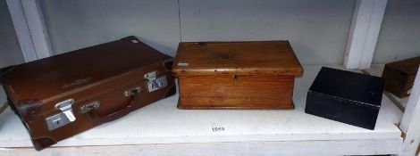 A small vintage suitcase and two wooden boxes