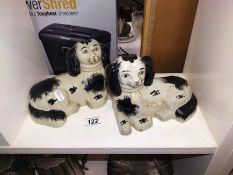 A pair of reclining Staffordshire dogs