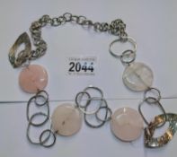 A Rose quartz necklace in a white metal