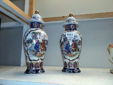 A pair of lidded Chinese vases. Height 32cm.