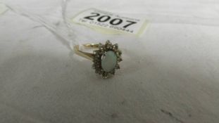 A 14ct yellow gold opal and diamond ring, size M, 2.5 grams.
