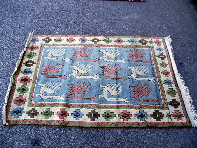 A Turkish style patterned rug. Length 193cm x 124cm. COLLECT ONLY.