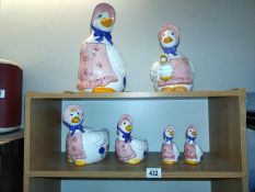 A quantity of ducks with bonnets including, a biscuit barrel, teapot and other pots.