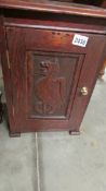 An Edwardian oak pot cupboard with dragon carved door, 34 x 34 x 49 cm. COLLECT ONLY.