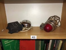 A chrome bell ringer and a 60's, 12 volt car breakdown lamp.