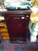 A dark wood stained single door cabinet with shelves and bottom drawer. (47cm x 49cm x height