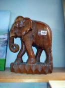 A carved wood elephant. COLLECT ONLY.