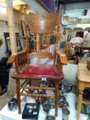 An ornate oak Carver chair with red leather seat. COLLECT ONLY.