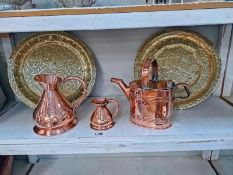 Two mid 20th Century Moroccan brass dishes, a copper watering can and two copper harvest jugs.