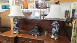 A pair of ceramic table lamps on metal bases complete with shades, 69cm. COLLECT ONLY.