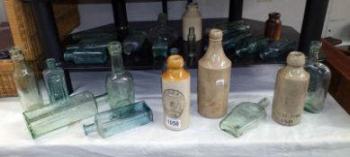 A quantity of vintage bottles including stoneware Lincoln ginger beer bottles