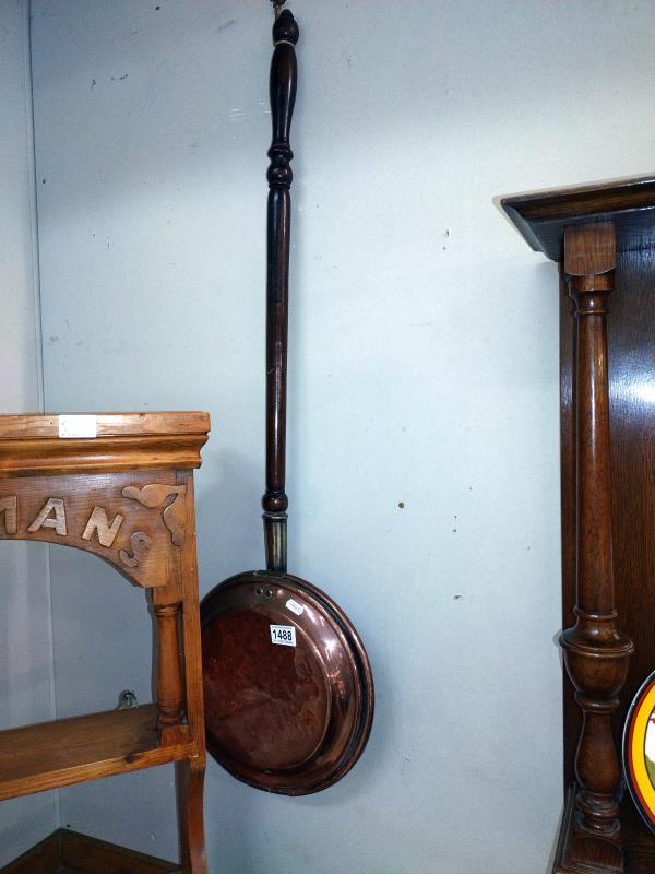 A Victorian copper warming pan.