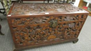 A heavily carved camphor wood blanket box, 101 x 51 x 61 cm tall, COLLECT ONLY.