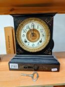 A Victorian black enamelled cast iron Mantle clock. 24cm x 12cm x Height 26cm. Springs ok but