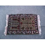 A pink middle eastern style rug. length 135cm x 83cm. COLLECT ONLY.