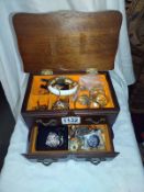 A jewellery box containing mainly earrings.