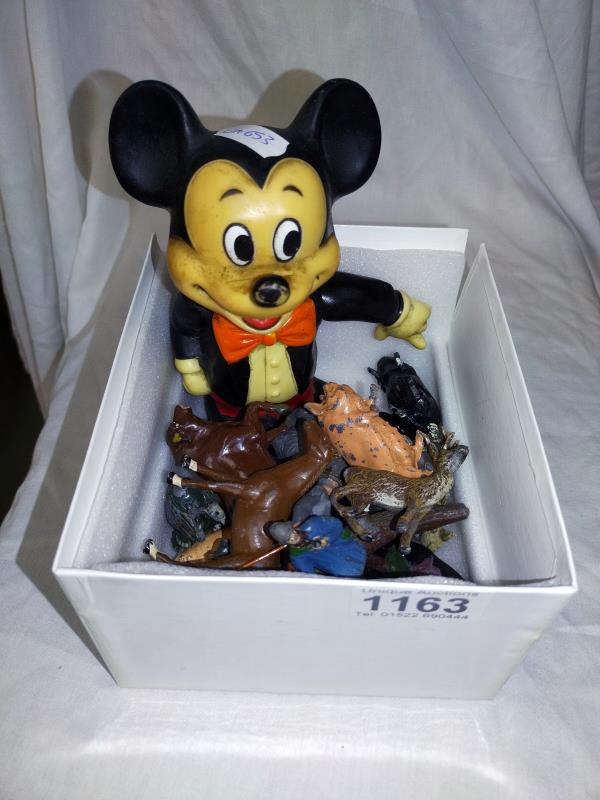 A vintage Mickey Mouse money box and a quantity of Britain's Lead farm animals and people.