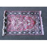 A pink floral rug with black border. COLLECT ONLY.