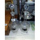 A pair of cut glass decanters, one stopper has chips to the bottom. With Sherry and Port labels.