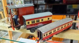 A tinplate railway carriage, a Triang railway carriage and a home built engine.