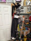 A Golf bag, with a selection of Golf clubs and an umbrella. COLLECT ONLY.