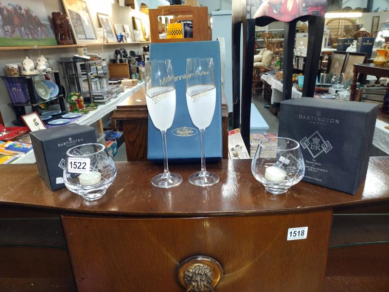 A boxed pair of Millenium flute glasses and a pair of Queens Diamond Jubilee candle holders.