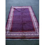 A blue and red patterned rug. Length 332 cm x 216cm. COLLECT ONLY.