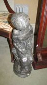 A concrete garden ornament of a seated girl, 63 cm tall, COLLECT ONLY.