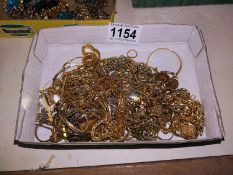 A tray of yellow metal costume jewellery