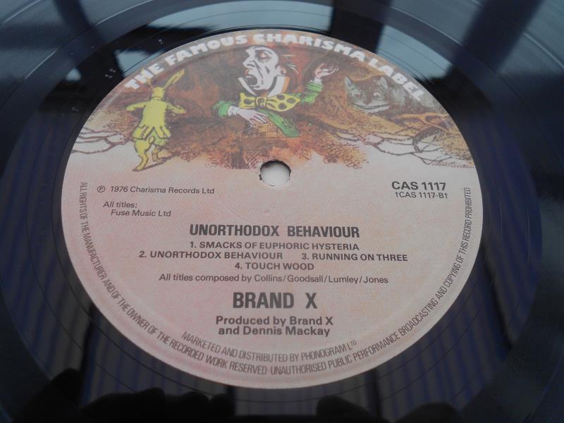 Brand X Unorthodox Behaviour UK 1st press LP CAS 1117 A-2 T and B-2 T EX+ The vinyl has a high - Image 8 of 11
