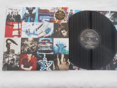 U2 ? Achtung Baby Rare original 1st press U28 with uncensored Adam and insert EX The vinyl is in