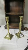 A pair of brass candlesticks.