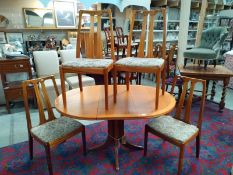 A Parker Knoll round extending dining table and 4 chairs. 100cm diameter extends to 138cm x 74cm