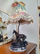A bronzed resin figural table lamp of a blacksmith with horse COLLECT ONLY