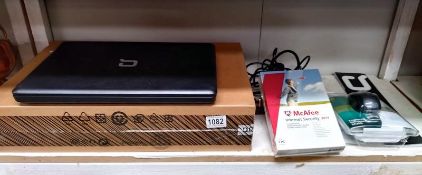 A boxed Compac laptop with accessories.