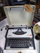 A cased Olympia traveller typewriter