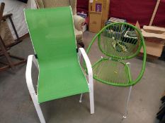 A pair of outside green chairs