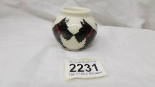 A small Moorcroft vase with Scotty Dog design.