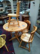 A substantial round pine table and 4 chairs- furniture of distinction by Geard and Harrison. 104cm