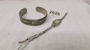 A silver elephant design bangle and a marcasite cocktail watch.