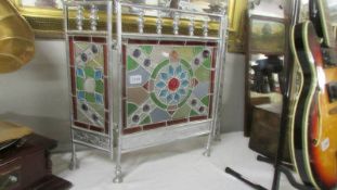 A lead glazed stained glass triple fire screen.