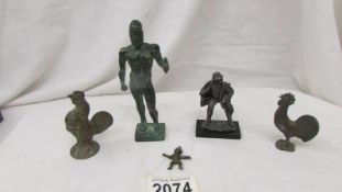 Two metal figures, two metal cockerels and a miniature figure.