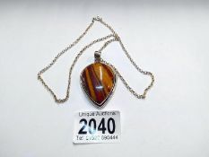 A heart shaped Jasper pendant set in silver with attached silver chain.