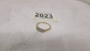A yellow gold three stone diamond ring, size L, 1.5 grams.