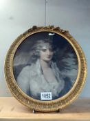 An oval framed and glazed print of a lady. 41cm x 35cm. (frame a/f)