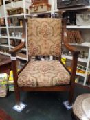 A 1930's oak arm chair with tapestry seat. COLLECT ONLY.