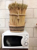 A 700 Watt microwave and a bakers display basket.