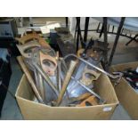 A large box of various saws and hammers